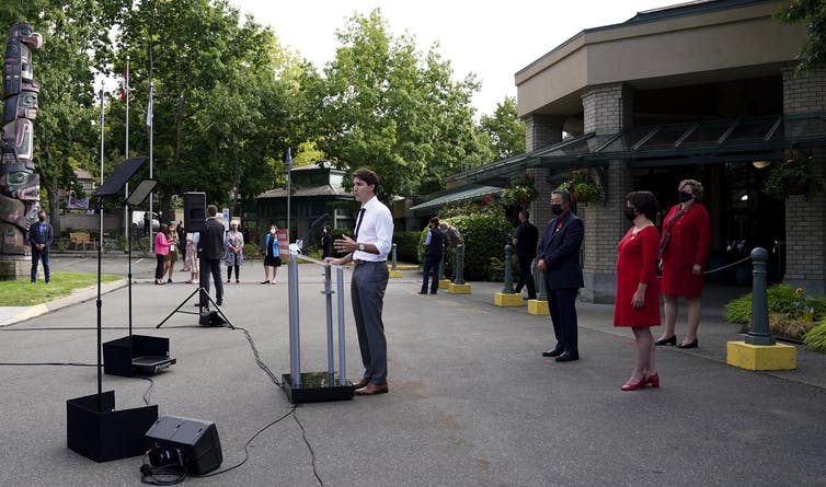 Liberal Leader Justin Trudeau standing at a microphone outside a building