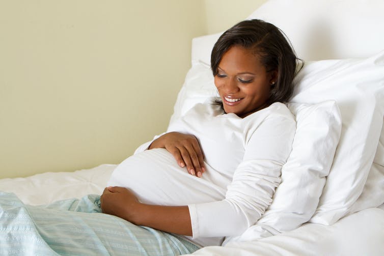 A pregnant woman in bed