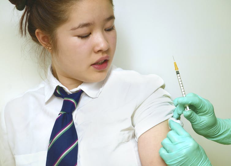 A schoolgirl receives the HPV vaccination.