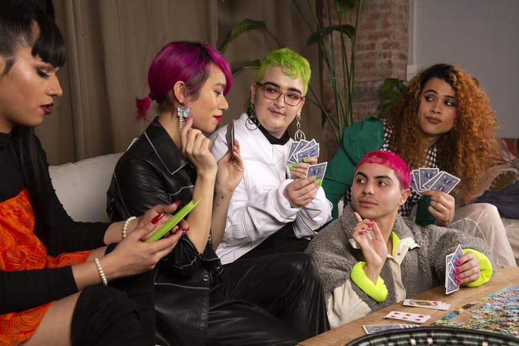 A group of friends of varying genders playing cards