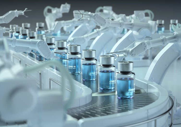 A number of vaccine vials on a production line.