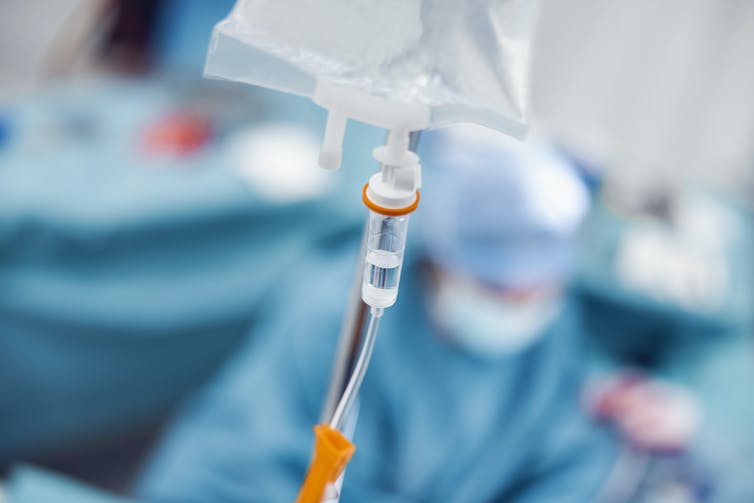 Close-up of IV drip in operating room.
