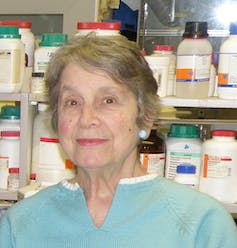 A woman in front of lab specimens.