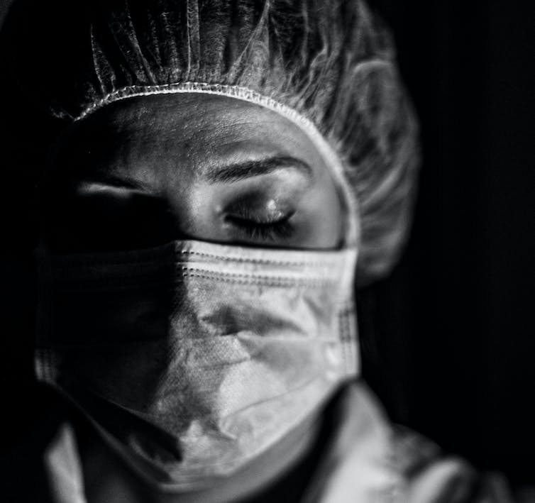 Black and white image of a nurse wearing a mask