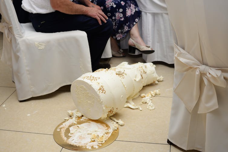 A wedding cake that has fallen to the floor