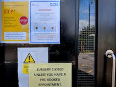 'Closed' signs on the door of a GP surgery