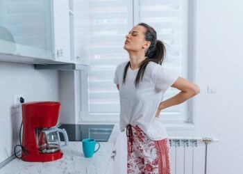 Millions across the world live with low back pain, but addressing major risk factors like smoking, obesity and workplace ergonomics could curb the trend, research shows