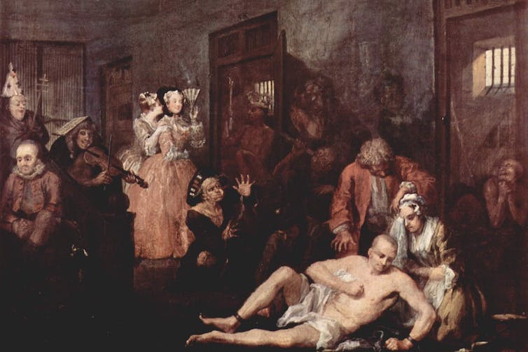 Painting of naked man being attended to in a madhouse.