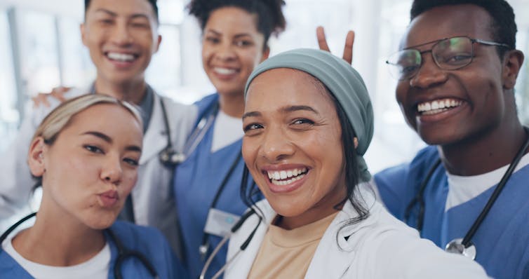 A group of health-care professionals taking a casual selfie