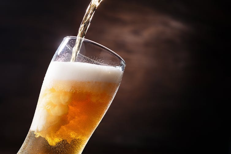Beer being poured into a beer glass.