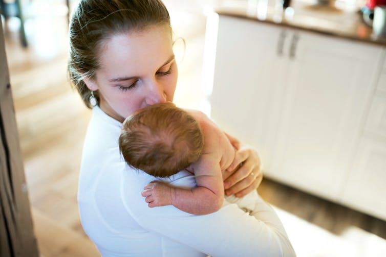 A mother holds a newborn baby.