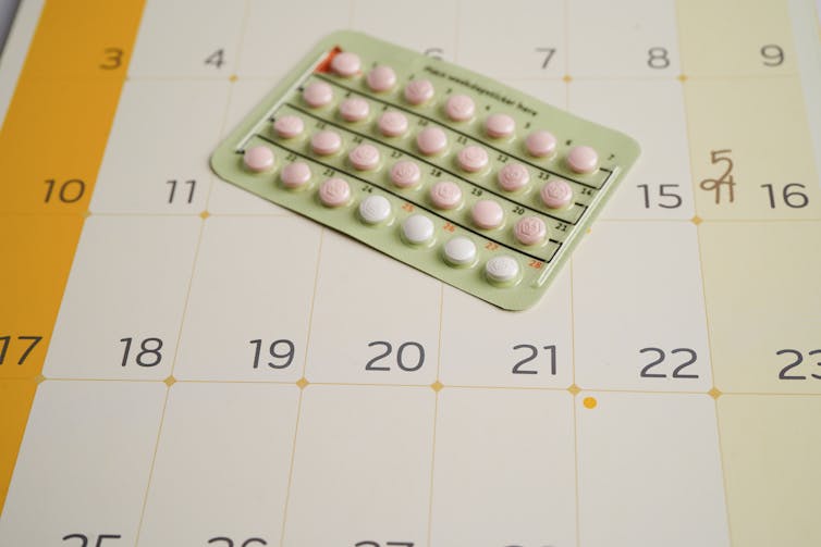 A pack of birth control pills on a calendar