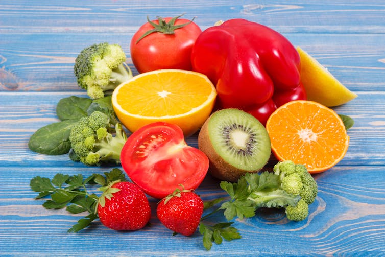 A collection of foods rich in vitamin C, including oranges, kiwi and peppers.