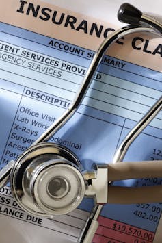 Stethoscope lying on top of health insurance bill