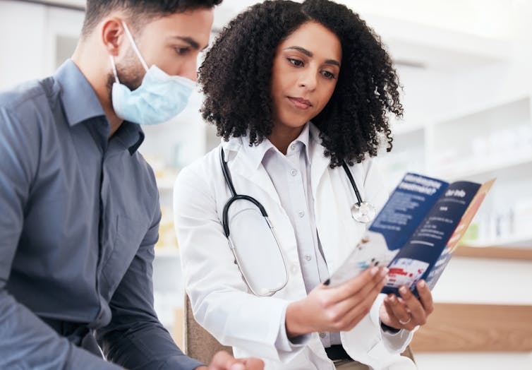 Doctor and patient looking at leaflet