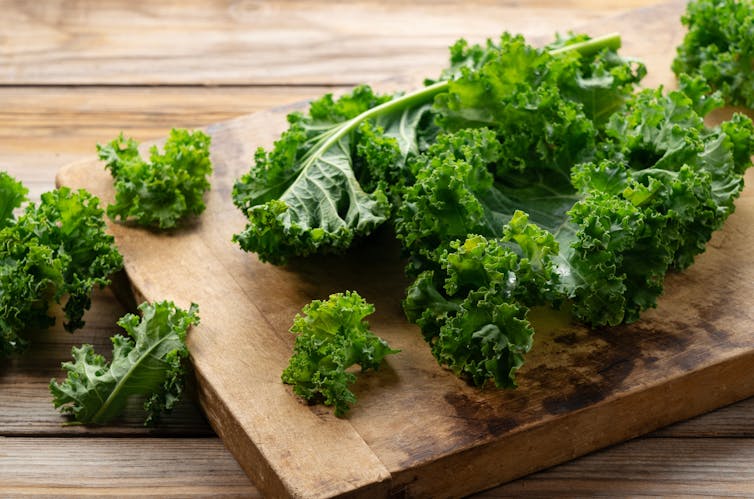 Kale on a wooden chopping board.