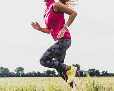 Young woman running in rural landscape