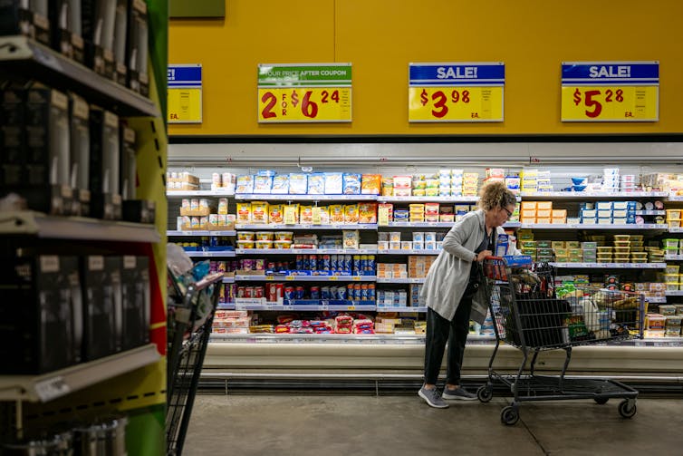 A customer shops for groceries in a supermarket.