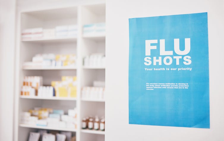 A pharmacy with a sign advertising flu shots