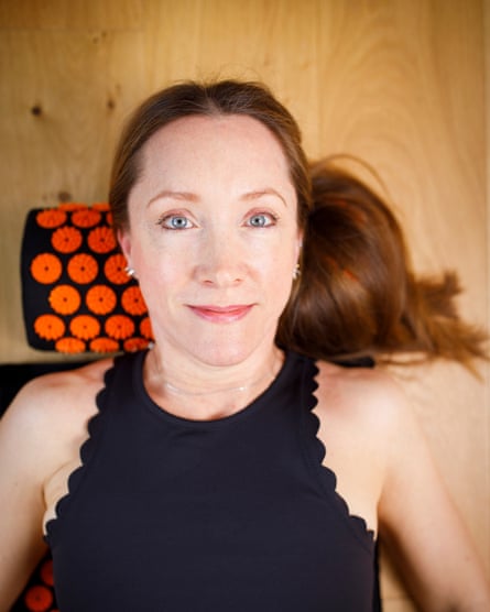 Amy lying on the floor facing the camera, lying on a spiked pillow and mat