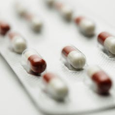 A blister pack of red and white capsules