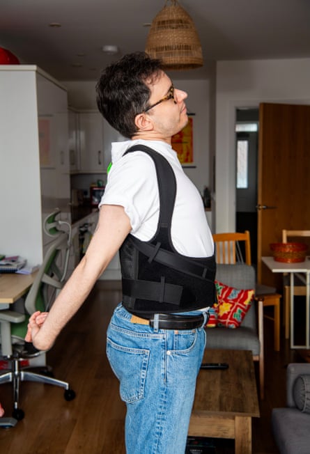 Craig doing a back stretch while wearing the corrector