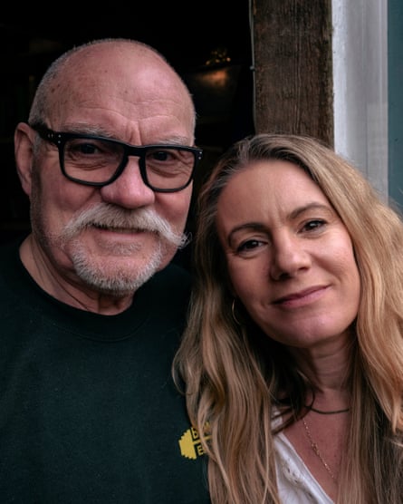 A close-up of White and Fowle standing in a doorway with their heads close together, smiling at the camera