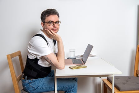 Craig tries out the posture corrector at his desk.
