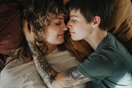 Intimate couple embracing on bed with eyes closed