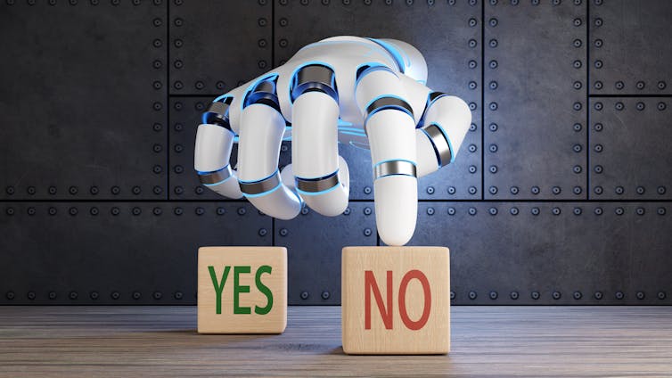 Two wooden cubes marked yes and no with robot hand pointing to no