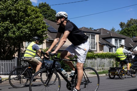 People riding bikes on a suburban street