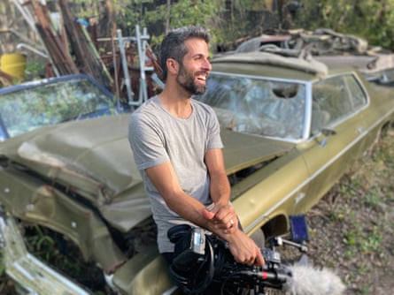 Israel Seoane leaning back on a car he is refurbishing