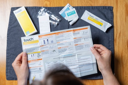 a woman reads the instructions for a vitamin D test by TouchBio