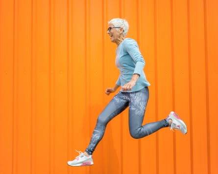 An older woman jumping in the air
