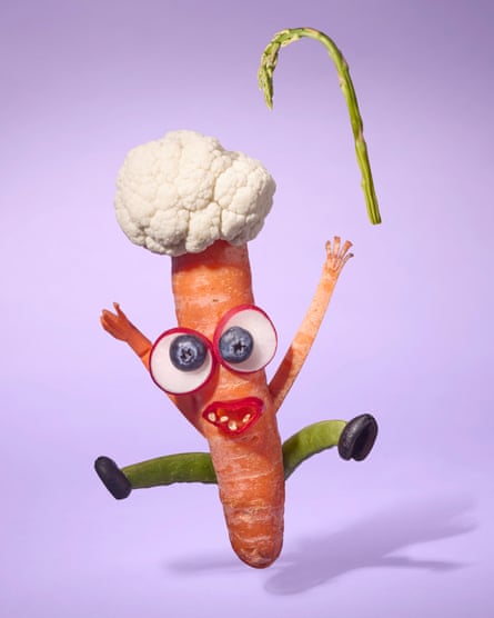 A carrot made into an old woman with cauliflower as white hair and beans for legs, jumping and throwing an asparagus cane up in the air