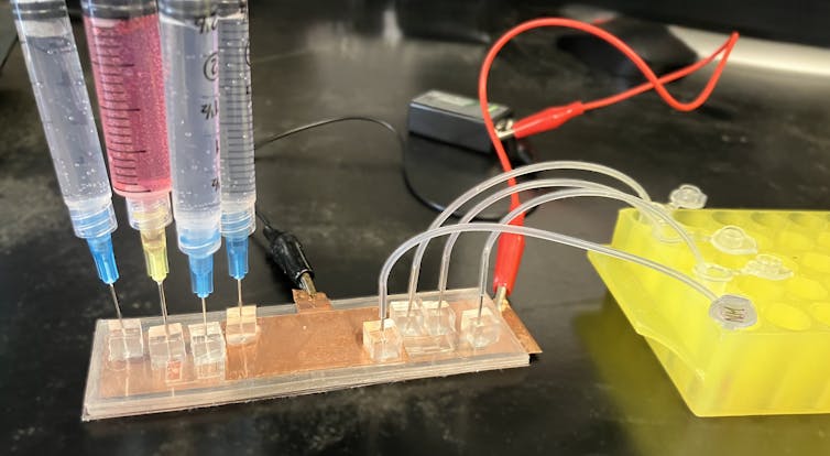 A prototype device with wires, test tubes and electrical current.