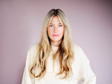 Bella Mackie wearing a white jumper against a pale-lilac background