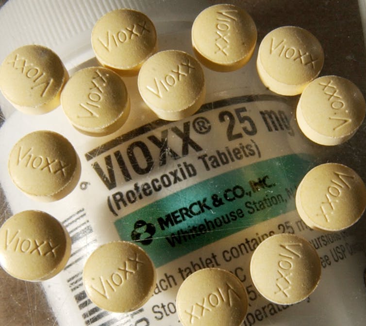 Close-up of bottle of Vioxx, with round pills arranged around it