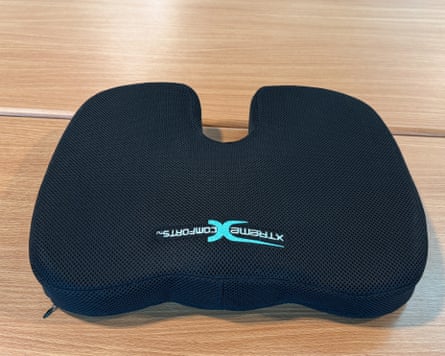 black seat cushion on wooden surface