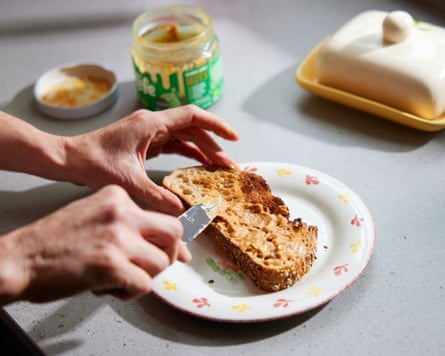 Emma Beddington spreading peanut butter on a slice of sourdough.