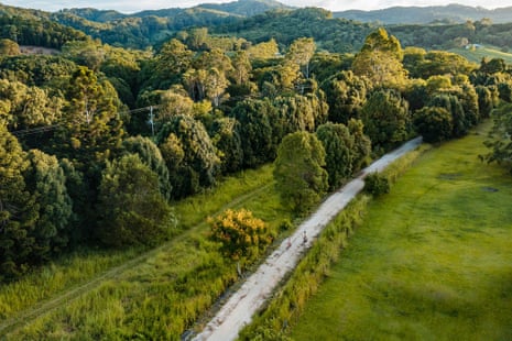Aerial view of cyclists on a rail trail surrounded by trees