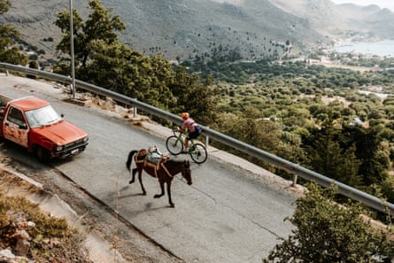 a cyclist tackles a hill on the island of Symi