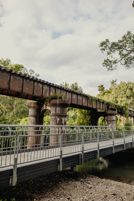 Cycling trail going over a river, alongside the old railway track