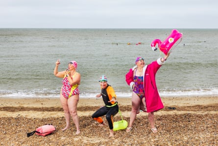 Swimmers (from left) Amanda Bowden, Seamus Bennett and Jenny Saltmarsh of the Swimscapes swimming club in Felixstowe, on the beach in all their kit