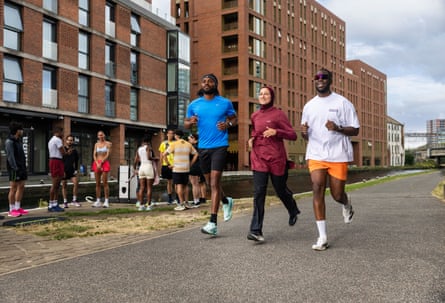 Runners (from left) Nico Junior, Habiba Hassan and André Lance of the Lost Culture running club in Leeds, running along a path