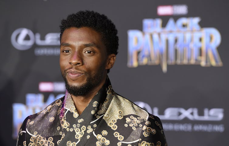 Headshot of Chadwick Boseman in front of Black Panther logo