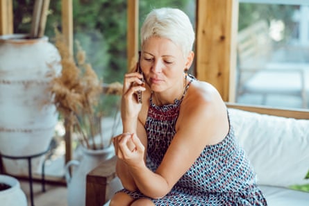 Woman sitting on a sofa listening to someone on her mobile