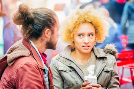 A man talking to a woman who looks horrified