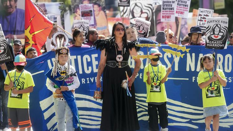 People seen with signs protesting mercury poisoning.