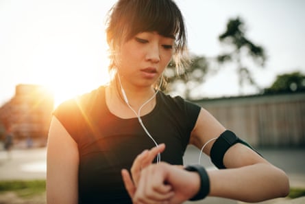 Close up shot of young sportswoman looking at smartwatch